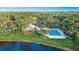 An aerial view showcases the inviting community pool, surrounded by trees, and a lake at 1846 Branchwater Trl, Orlando, FL 32825