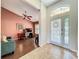 Welcoming entryway leads to office space, showcasing a bright foyer with natural light and hardwood floors at 1846 Branchwater Trl, Orlando, FL 32825