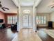 Bright foyer with a decorative front door, tile flooring, and views into the adjacent living spaces at 1846 Branchwater Trl, Orlando, FL 32825