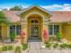 Elegant front entrance with decorative plants, a well-manicured lawn, and a charming front door at 1846 Branchwater Trl, Orlando, FL 32825