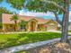 Inviting single-story home featuring a manicured lawn, well-kept landscaping, and a two-car garage at 1846 Branchwater Trl, Orlando, FL 32825