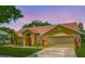 Charming single-Gathering home with a well-manicured lawn, lush landscaping, and a two-car garage at 1846 Branchwater Trl, Orlando, FL 32825