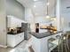 Eat-in kitchen featuring white cabinets, granite counters, stainless appliances and pendant lighting at 1846 Branchwater Trl, Orlando, FL 32825