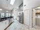 Open kitchen with granite countertops, stainless appliances, and laundry room access at 1846 Branchwater Trl, Orlando, FL 32825