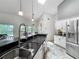 Kitchen with stainless appliances, granite countertops, a skylight and adjacent dining area at 1846 Branchwater Trl, Orlando, FL 32825