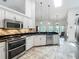 Spacious kitchen featuring stainless steel appliances, stone backsplash, and eat-in breakfast area at 1846 Branchwater Trl, Orlando, FL 32825