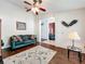 Cozy living room boasts hardwood floors, ceiling fan, neutral walls, and comfortable seating at 1846 Branchwater Trl, Orlando, FL 32825