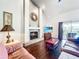 Living room featuring a fireplace, hardwood floors, large windows, and view of the pool area at 1846 Branchwater Trl, Orlando, FL 32825