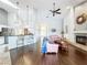 Open-concept living room with fireplace, hardwood floors, breakfast bar, and seamless flow to kitchen at 1846 Branchwater Trl, Orlando, FL 32825