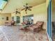 Covered patio features tile flooring, ceiling fans, and comfortable seating, perfect for outdoor relaxation at 1846 Branchwater Trl, Orlando, FL 32825