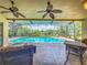 Inviting screened-in pool area with stylish patio furniture and a picturesque lake view at 1846 Branchwater Trl, Orlando, FL 32825
