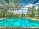 Refreshing pool with an attached spa surrounded by a screened enclosure and landscaped yard at 1846 Branchwater Trl, Orlando, FL 32825