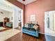Comfortable sitting area with hardwood floors, neutral paint, and transition to other living spaces at 1846 Branchwater Trl, Orlando, FL 32825