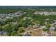 Aerial view of a home in a neighborhood surrounded by lush trees and greenery at 2045 South St, Oviedo, FL 32765
