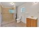 Bathroom with a tiled shower, vanity, and toilet at 2045 South St, Oviedo, FL 32765