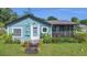 Charming single-story home with blue siding and a screened front porch at 2045 South St, Oviedo, FL 32765
