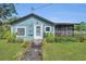 Charming home exterior with a well-kept lawn and inviting entryway at 2045 South St, Oviedo, FL 32765