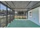 Screened-in porch with green carpet flooring and views of the outdoors at 2045 South St, Oviedo, FL 32765