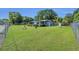 Expansive yard surrounding the home, enclosed with a chain-link fence at 2045 South St, Oviedo, FL 32765