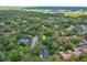 Aerial view showing property's location surrounded by lush greenery and a dense tree canopy in the neighborhood at 209 Sweet Gum Way, Longwood, FL 32779