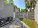 Exterior backyard shot of the property featuring a fenced yard, AC units, and stone and grass landscaping at 209 Sweet Gum Way, Longwood, FL 32779