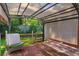 Backyard features wooden deck with awning, chairs, and artificial turf at 209 Sweet Gum Way, Longwood, FL 32779