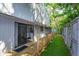 Backyard area featuring a wooden deck, artificial turf, and sliding glass door at 209 Sweet Gum Way, Longwood, FL 32779