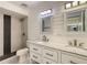 Beautifully updated bathroom featuring dual sinks, marble countertop, modern fixtures, and a tiled shower with a glass door at 209 Sweet Gum Way, Longwood, FL 32779