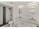 Bright bathroom with dual sinks, stand-up shower with rainfall shower head, and shiplap accent wall at 209 Sweet Gum Way, Longwood, FL 32779