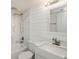 Bathroom with marble shower, bathtub, shiplap wall, and vanity with faucet at 209 Sweet Gum Way, Longwood, FL 32779
