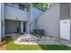 Home exterior showcasing a small stone landscaped garden with nearby AC units and a door leading to a fenced yard at 209 Sweet Gum Way, Longwood, FL 32779