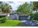 Charming home featuring a two-car garage, well-maintained lawn, and mature trees providing ample shade at 209 Sweet Gum Way, Longwood, FL 32779