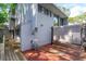 Back of house exterior features a wooden deck, awning, and gray siding at 209 Sweet Gum Way, Longwood, FL 32779