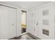 Bright foyer features a closet, a decorative door with mirrored squares, and stylish gray wood-look flooring at 209 Sweet Gum Way, Longwood, FL 32779