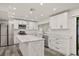 Bright kitchen features an island, stainless steel appliances, and white cabinetry and marble countertops at 209 Sweet Gum Way, Longwood, FL 32779