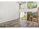 Spacious living room with vaulted ceiling, large windows, sliding glass doors, and hardwood floors at 209 Sweet Gum Way, Longwood, FL 32779