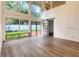 Bright living room with hardwood floors, large windows providing ample natural light, and a sliding door to the back yard at 209 Sweet Gum Way, Longwood, FL 32779