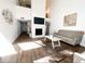 Open-concept living room featuring modern decor, sleek flooring, and a stylish fireplace with flat screen television at 209 Sweet Gum Way, Longwood, FL 32779