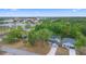 Aerial view showcases the house in a neighborhood with trees at 2137 Brighton Ln, Orlando, FL 32817