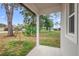 Covered back porch with ample room for entertaining overlooking a grassy yard at 2137 Brighton Ln, Orlando, FL 32817