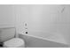 White bathroom features a standard toilet and a bright white bathtub at 2137 Brighton Ln, Orlando, FL 32817