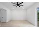 Minimalist bedroom with light wood floors, modern ceiling fan, and a door to the left at 2137 Brighton Ln, Orlando, FL 32817