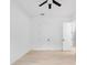 Empty bedroom featuring hardwood floors, fan, and two doors at 2137 Brighton Ln, Orlando, FL 32817