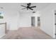 Large room with carpeted floors, neutral walls, large windows and staircase with white railing at 2137 Brighton Ln, Orlando, FL 32817