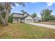 Two story home with a gray exterior, a front-facing two-car garage, and a long concrete driveway at 2137 Brighton Ln, Orlando, FL 32817