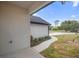 Side view of home with walkway, garden bed, grass, and landscaping at 2137 Brighton Ln, Orlando, FL 32817