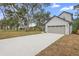 Two story home with a gray exterior, a front-facing two-car garage, and a long concrete driveway at 2137 Brighton Ln, Orlando, FL 32817
