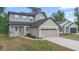 Two-story home with grey siding, a two-car garage, and well-maintained landscaping at 2137 Brighton Ln, Orlando, FL 32817