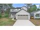 Two-story home with grey siding, a two-car garage, and well-maintained landscaping at 2137 Brighton Ln, Orlando, FL 32817