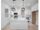 Modern, all-white kitchen with stainless appliances, modern light fixtures, and a center island at 2137 Brighton Ln, Orlando, FL 32817